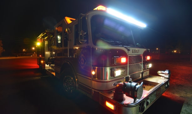 A photograph of a firetruck at night illuminating the scene with scene LED Lights by Firetech HiViz Lighting.