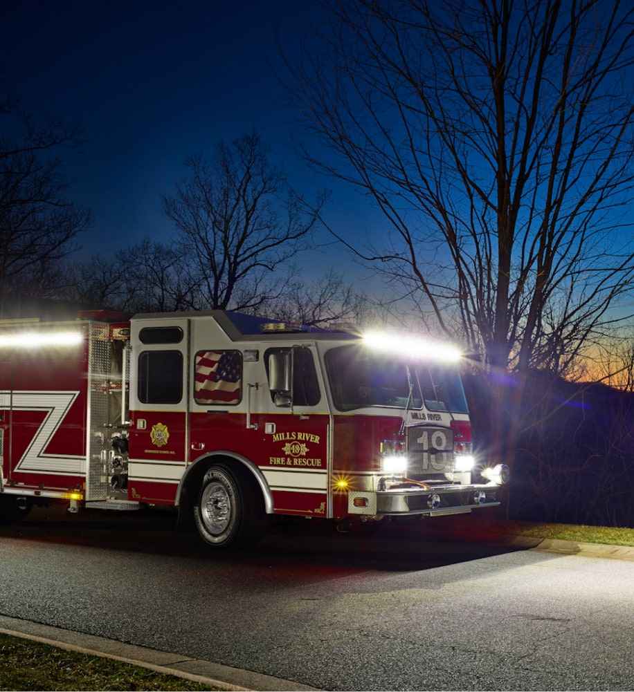 A photogarph of a firetruck at night illuminating the scene with various types of LED Lights by FireTech.