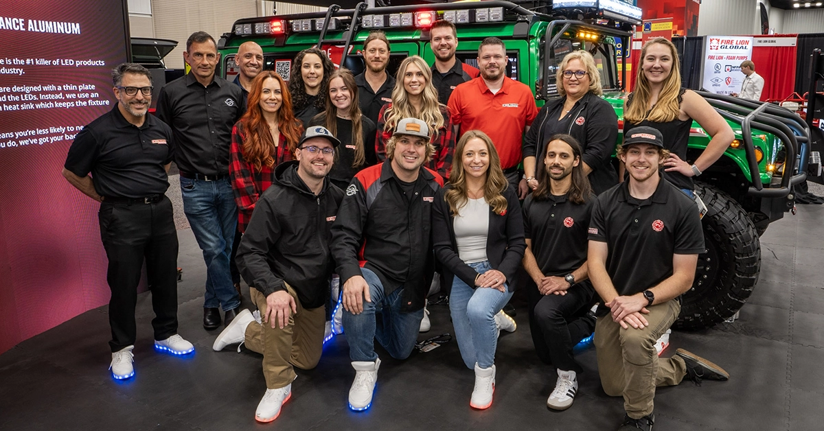 Firelion team having a team photo in front of a emergency response truck